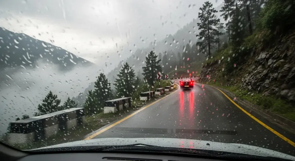 Foggy hill road safety during rain in Indian mountains